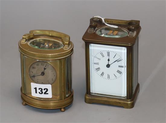 An oval brass carriage timepiece and one other